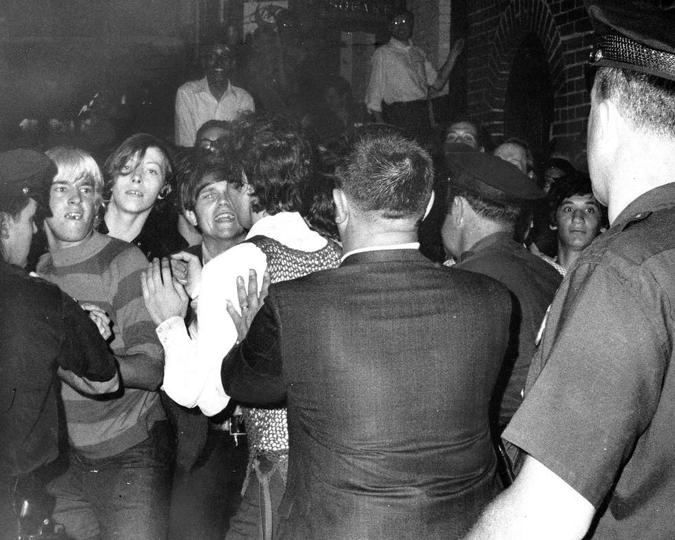 Monochrome, crowd of people getting ciolented by police forces at the Stonewall Riots